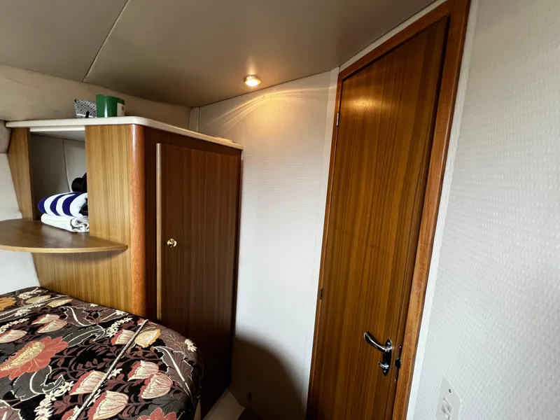 Slide: The Image of Interior cabin of 2001 Bayliner 3488 Command Bridge Motoryacht with wood accents and cozy decor. - 42