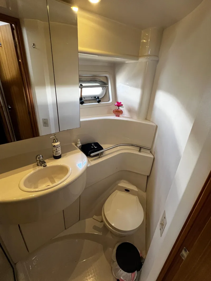 Slide: The Image of 2001 Bayliner 3488 Command Bridge Motoryacht bathroom with sink, toilet, and mirror. - 44