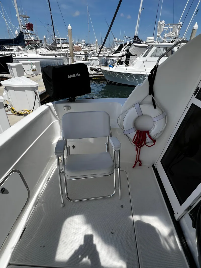 Slide: The Image of 2001 Bayliner 3488 Command Bridge Motoryacht deck with chair and life preserver. - 5