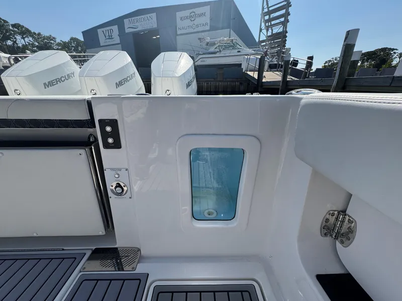 Slide: The Image of 2024 Tidewater 380 CC Adventure boat with Mercury engines at a marina. - 12