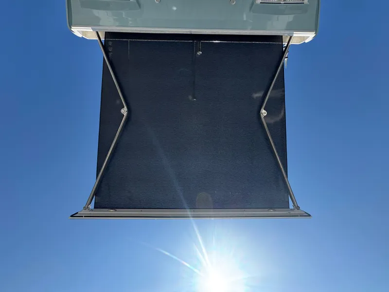 Slide: The Image of 2024 Tidewater 380 CC Adventure boat awning against clear blue sky. - 15
