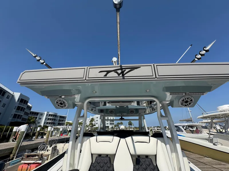 Slide: The Image of 2024 Tidewater 380 CC Adventure boat at marina, featuring sleek design and modern amenities. - 16