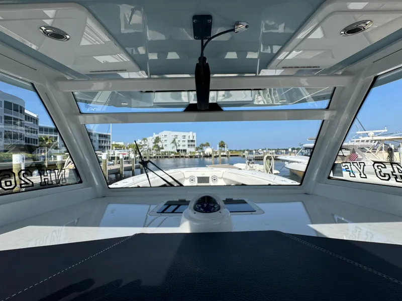 Slide: The Image of 2024 Tidewater 380 CC Adventure boat interior with marina view through windshield. - 22