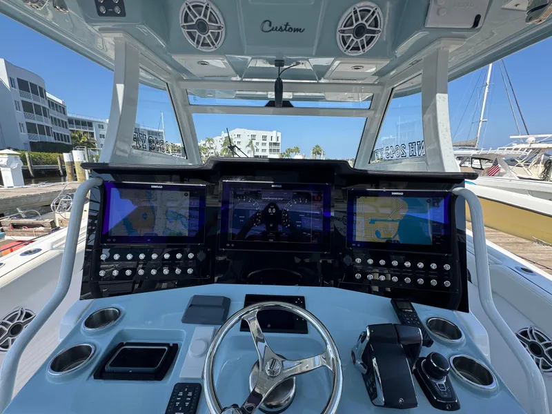 Slide: The Image of 2024 Tidewater 380 CC Adventure helm with advanced navigation displays and controls. - 23