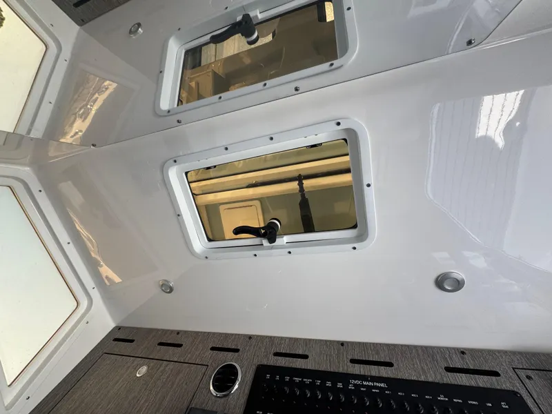 Slide: The Image of Interior view of 2024 Tidewater 380 CC Adventure boat with windows and control panel. - 26