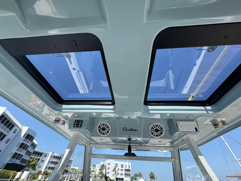 Slide: The Image of 2024 Tidewater 380 CC Adventure boat interior with skylights and speakers, showcasing modern design. - 31