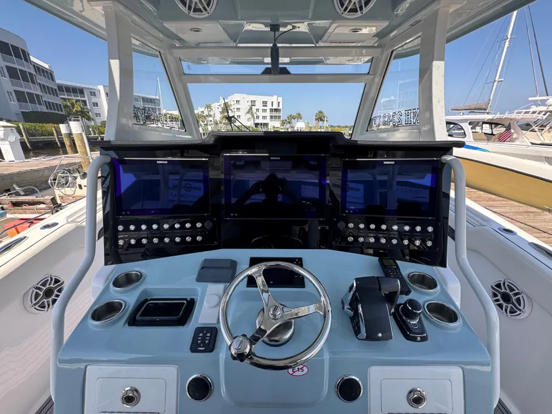 Slide: The Image of 2024 Tidewater 380 CC Adventure boat dashboard with advanced navigation controls and displays. - 32