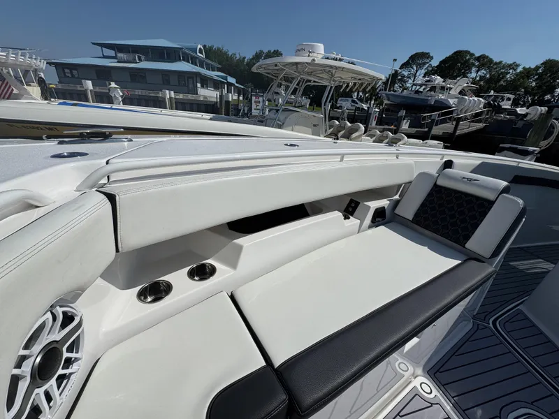 Slide: The Image of 2024 Tidewater 380 CC Adventure boat interior with white seating and cup holders. - 36