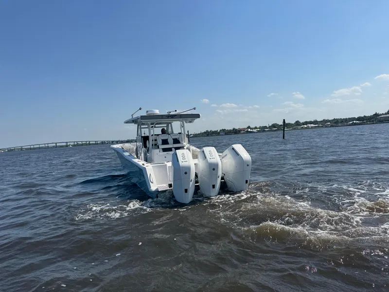 Slide: The Image of 2024 Tidewater 380 CC Adventure boat cruising on open water under clear skies. - 42