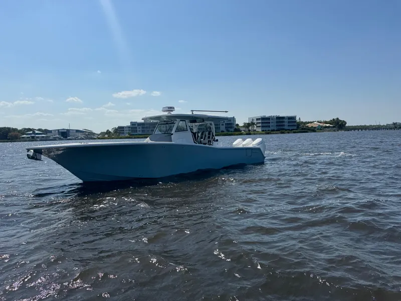 Slide: The Image of 2024 Tidewater 380 CC Adventure boat cruising on a sunny day. - 6