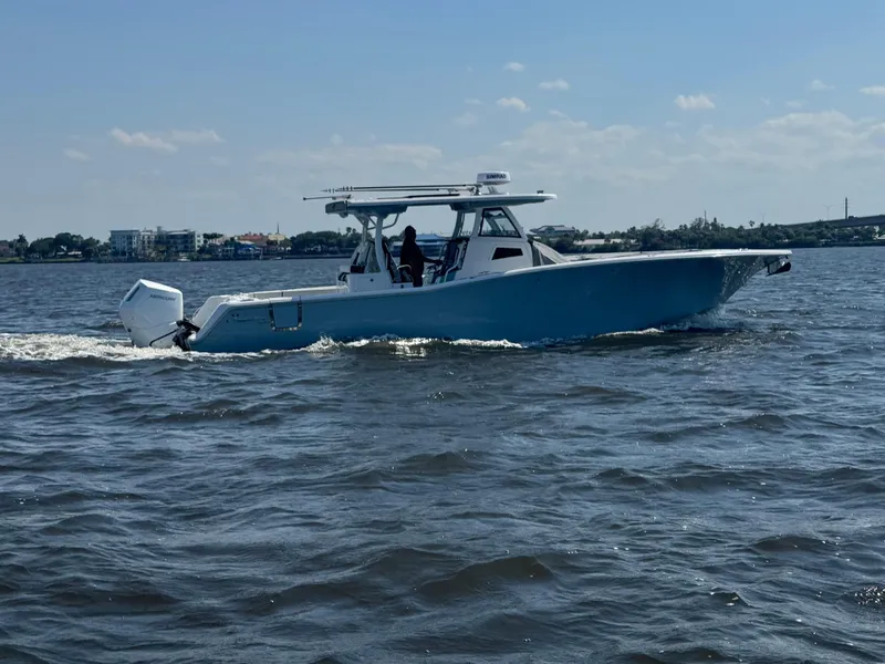 Slide: The Image of 2024 Tidewater 380 CC Adventure boat deck with seating and water view. - 7