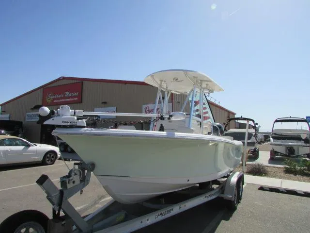Slide: The Image of 2021 Sea Hunt 219 Ultra boat on trailer, parked outside a marine dealership. - 10