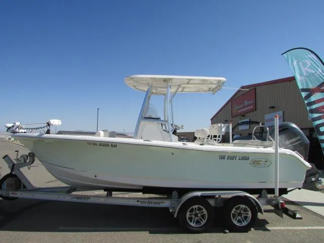 Slide: The Image of 2021 Sea Hunt 219 Ultra boat on trailer, parked outdoors under clear blue sky. - 11