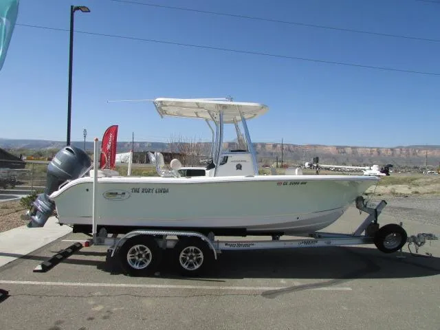 Slide: The Image of 2021 Sea Hunt 219 Ultra boat on trailer, parked outdoors under clear blue sky. - 12