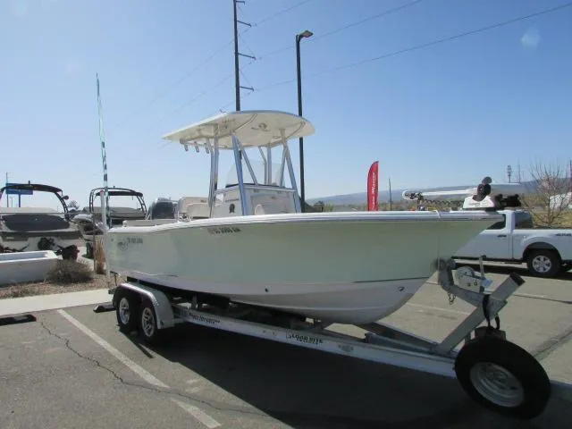 Slide: The Image of 2021 Sea Hunt 219 Ultra boat on trailer in parking lot, sunny day. - 13