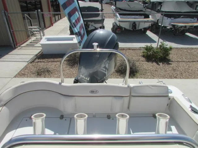 Slide: The Image of 2021 Sea Hunt 219 Ultra boat with Yamaha engine, docked near other boats. - 16