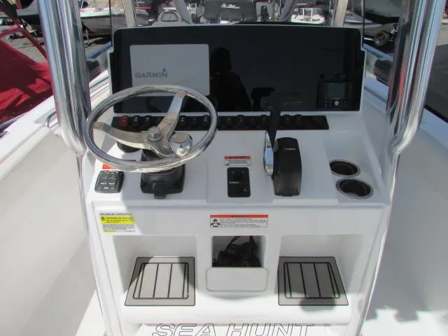 Slide: The Image of 2021 Sea Hunt 219 Ultra boat console with Garmin display and steering wheel. - 17
