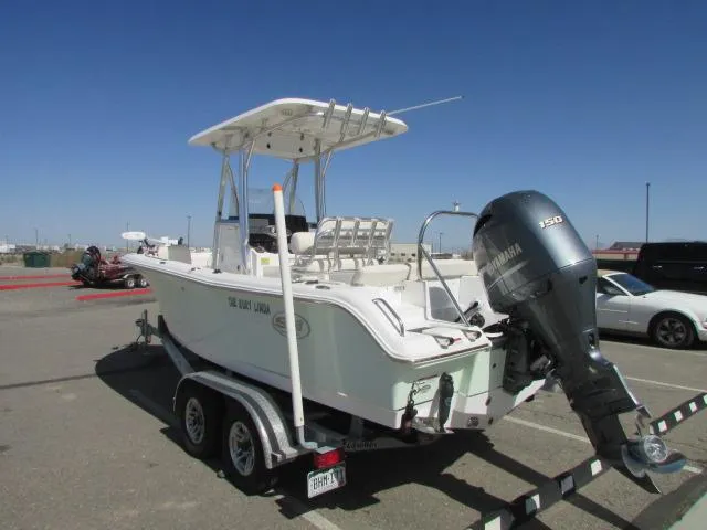 Slide: The Image of 2021 Sea Hunt 219 Ultra boat on trailer with Yamaha 150 engine in parking lot. - 2