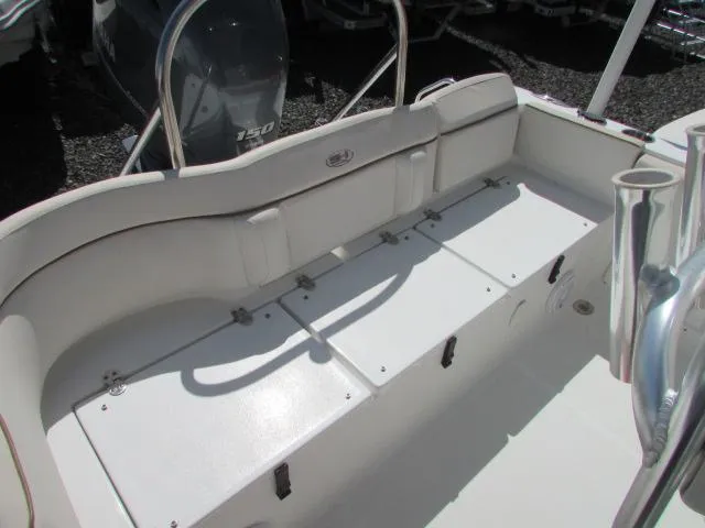 Slide: The Image of 2021 Sea Hunt 219 Ultra boat interior with cushioned seating and storage compartments. - 22