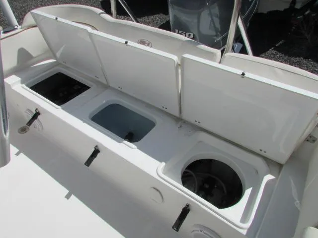 Slide: The Image of 2021 Sea Hunt 219 Ultra boat storage compartments with open lids, showcasing interior features. - 8
