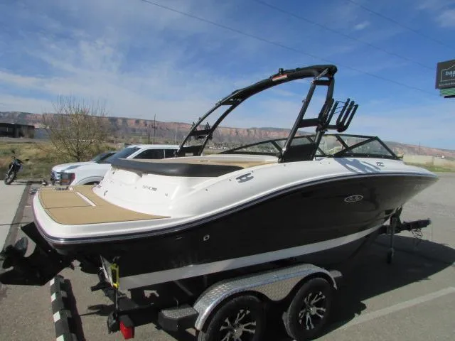 Slide: The Image of 2023 Sea Ray 190 Sport boat on trailer, parked outdoors under clear sky. - 4