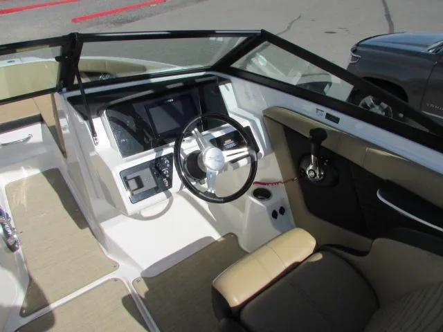 Slide: The Image of 2023 Sea Ray 190 Sport boat interior with steering wheel and dashboard controls. - 5