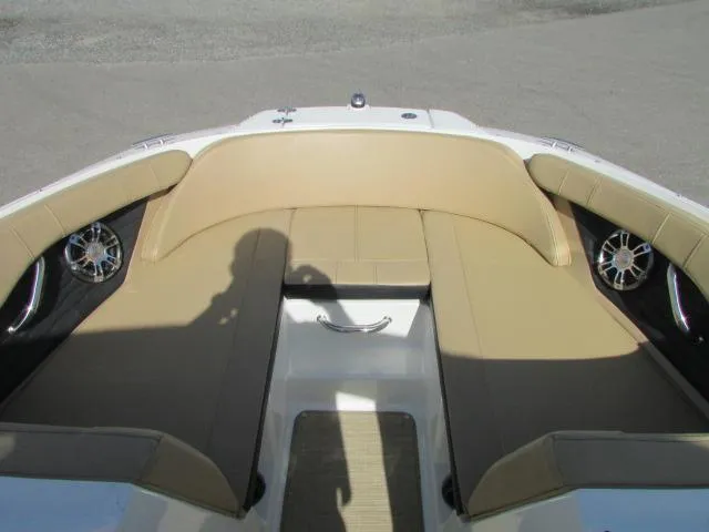 Slide: The Image of 2023 Sea Ray 190 Sport boat interior with tan seating and speaker system. - 6