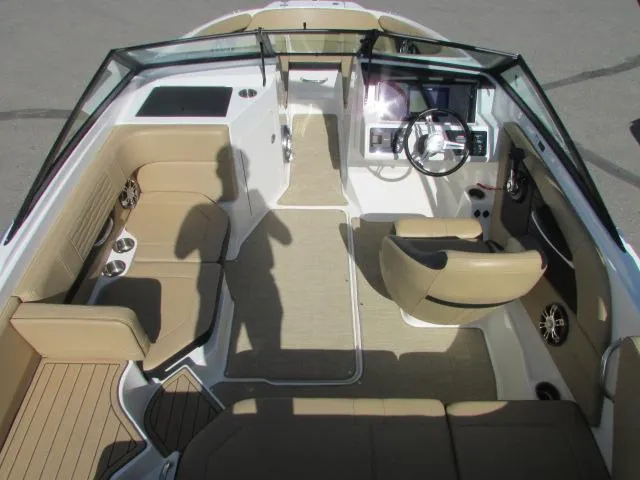 Slide: The Image of 2023 Sea Ray 190 Sport boat interior with tan seating and modern dashboard. - 8