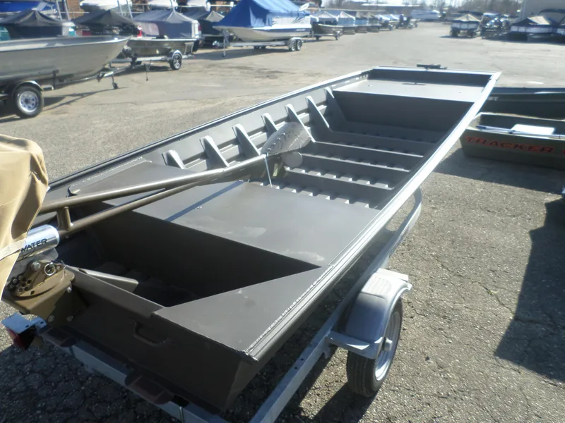 Slide: The Image of 2025 Alweld 1542 Jon boat on trailer in a marina setting. - 11