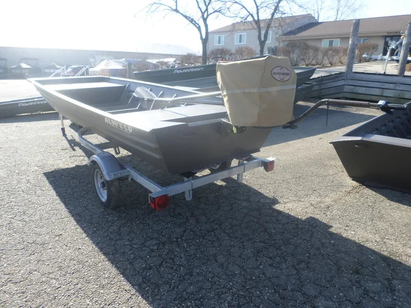 Slide: The Image of 2025 Alweld 1542 Jon boat on trailer, outdoor setting, sunny day. - 4