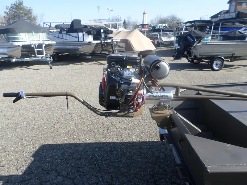 Slide: The Image of 2025 Alweld 1542 Jon boat with Backwater motor in a boatyard. - 9