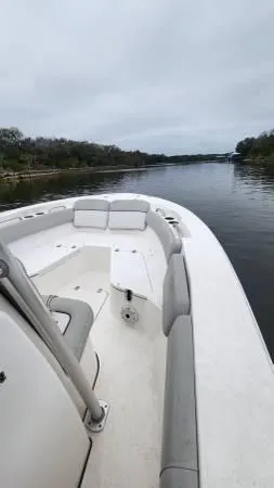 Slide: The Image of 2022 Sea Fox 228 Commander boat cruising on a calm river under overcast skies. - 9