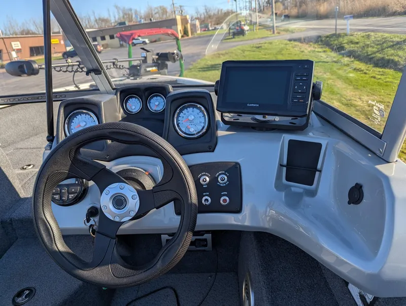 Slide: The Image of 2019 Tracker Pro Guide V-165 WT boat dashboard with steering wheel and Garmin display. - 3