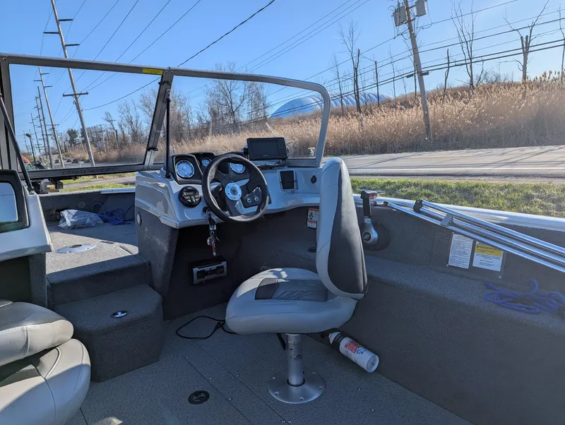 Slide: The Image of 2019 Tracker Pro Guide V-165 WT boat interior with steering wheel and seating. - 4