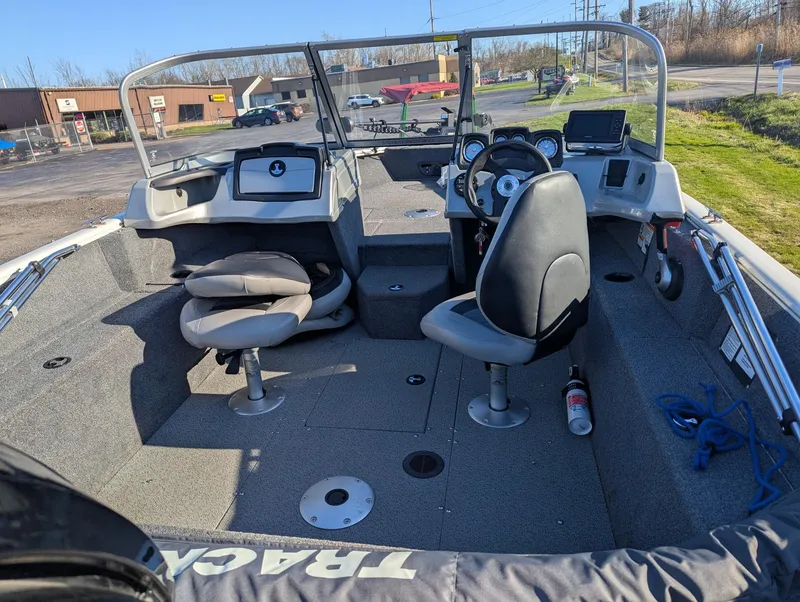 Slide: The Image of 2019 Tracker Pro Guide V-165 WT boat interior with seating and steering console. - 7