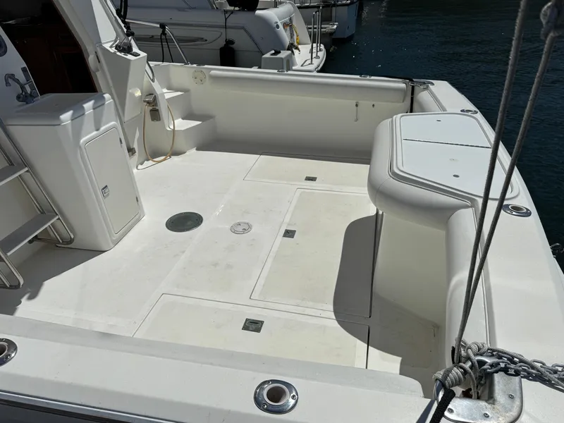 Slide: The Image of 2003 Mediterranean 38 Convertible boat deck with seating and storage compartments. - 13