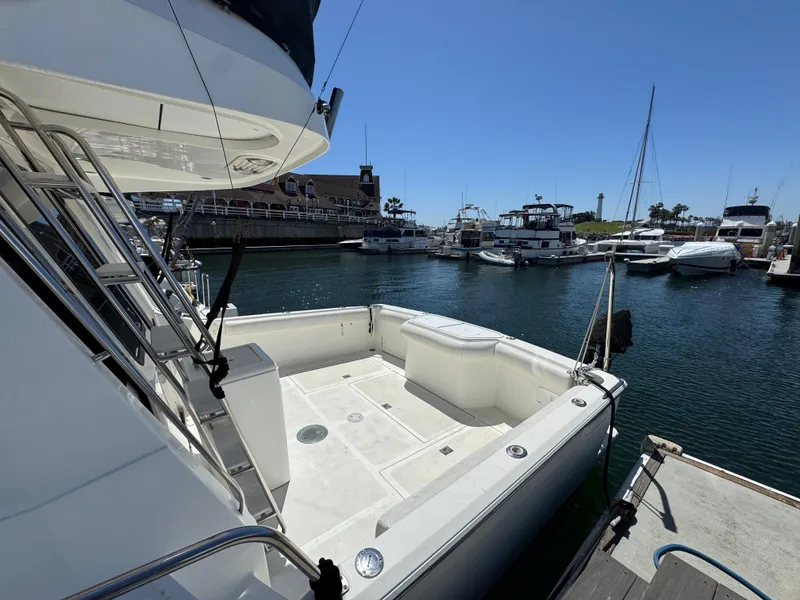 Slide: The Image of 2003 Mediterranean 38 Convertible yacht docked at a marina under clear blue skies. - 14