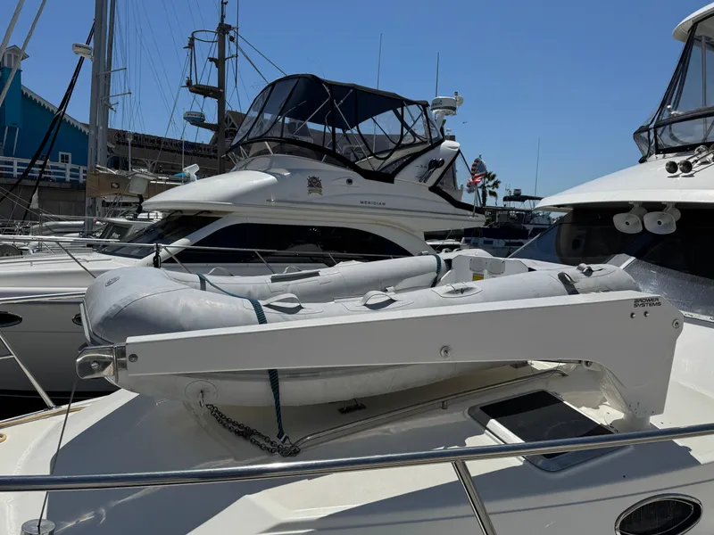 Slide: The Image of 2003 Mediterranean 38 Convertible yacht with inflatable dinghy on deck, docked at marina. - 18