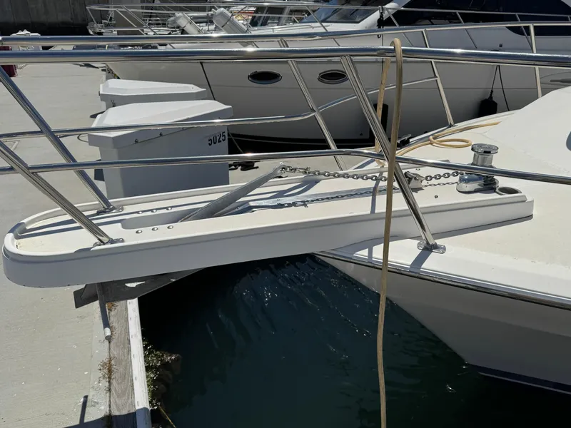 Slide: The Image of 2003 Mediterranean 38 Convertible yacht docked with visible bow and railing. - 19