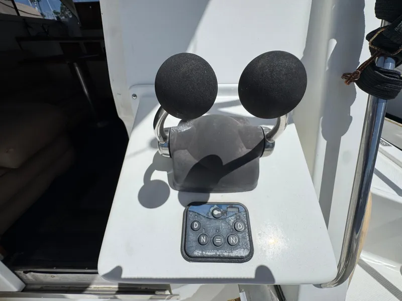 Slide: The Image of Control panel of a 2003 Mediterranean 38 Convertible boat with dual throttle levers. - 21