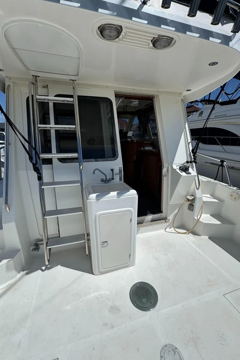 Slide: The Image of 2003 Mediterranean 38 Convertible yacht deck with ladder and door. - 22
