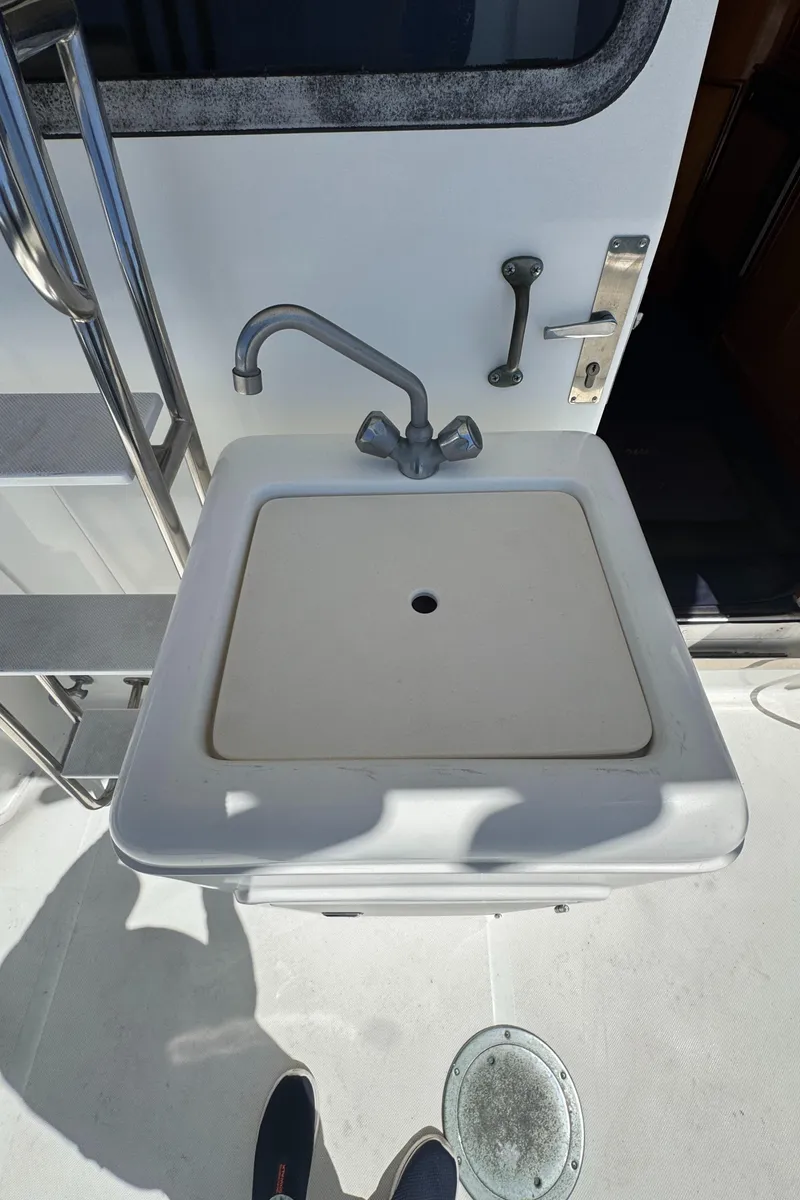 Slide: The Image of Boat sink on 2003 Mediterranean 38 Convertible yacht, featuring stainless steel fixtures. - 23