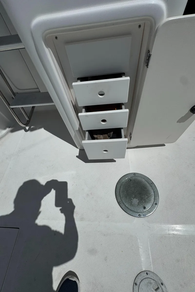 Slide: The Image of 2003 Mediterranean 38 Convertible boat interior with open storage drawers. - 24