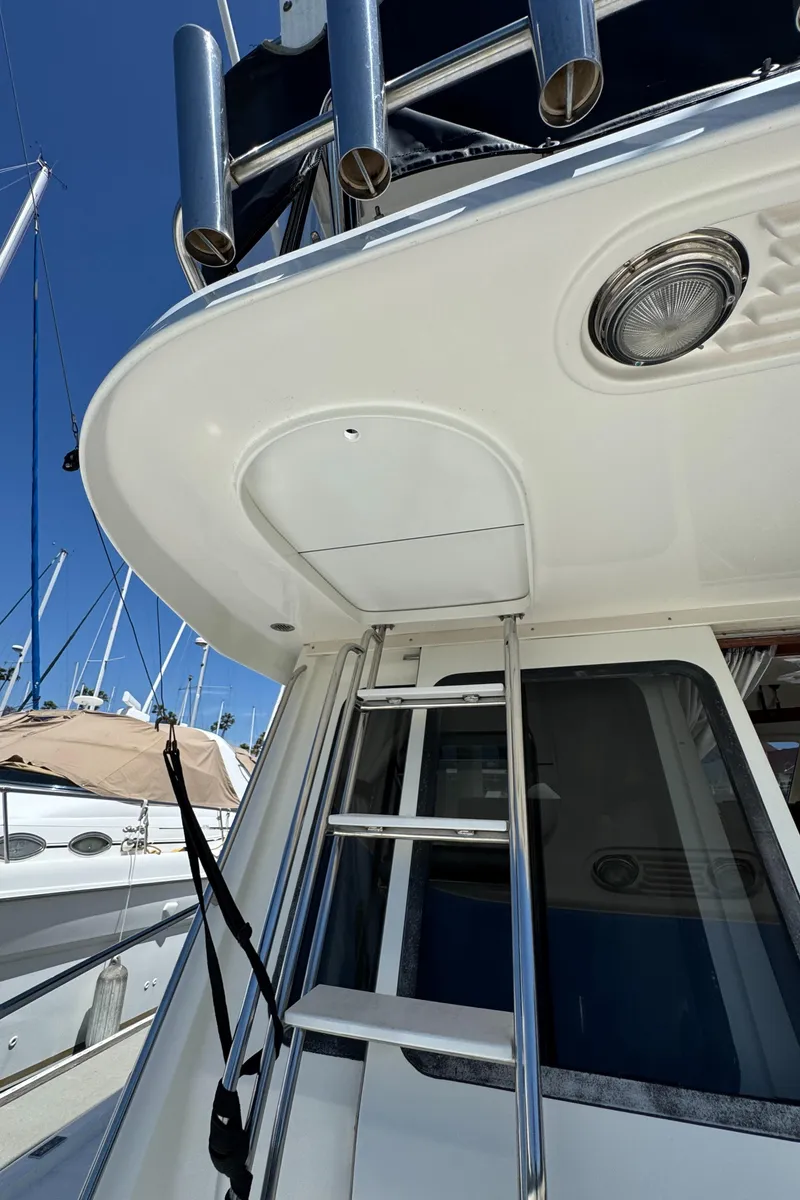 Slide: The Image of 2003 Mediterranean 38 Convertible yacht ladder and deck view. - 25