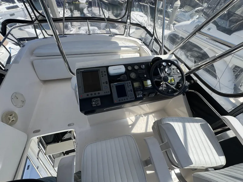 Slide: The Image of Cockpit of 2003 Mediterranean 38 Convertible yacht with steering wheel and navigation controls. - 31