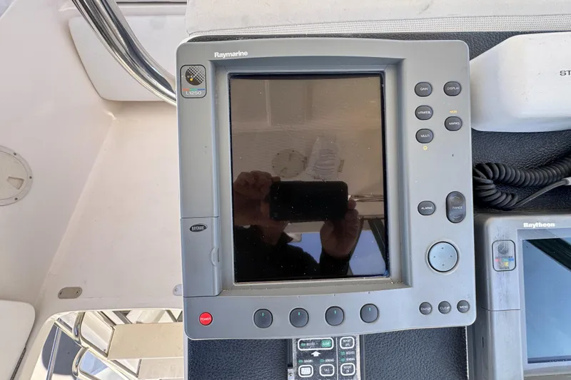 Slide: The Image of Raymarine navigation system on 2003 Mediterranean 38 Convertible boat dashboard. - 33