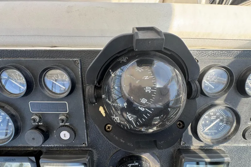 Slide: The Image of Compass and gauges on 2003 Mediterranean 38 Convertible boat dashboard. - 37