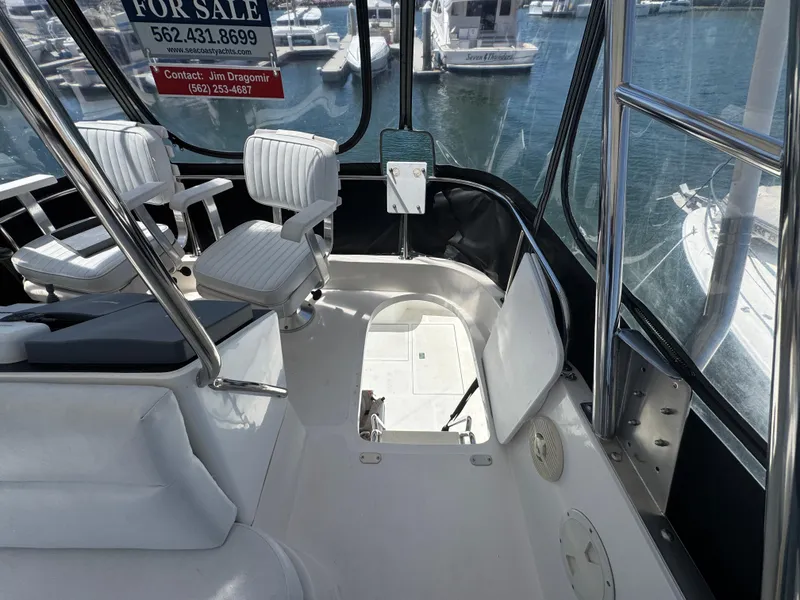 Slide: The Image of 2003 Mediterranean 38 Convertible yacht interior with white seating, for sale sign visible. - 45