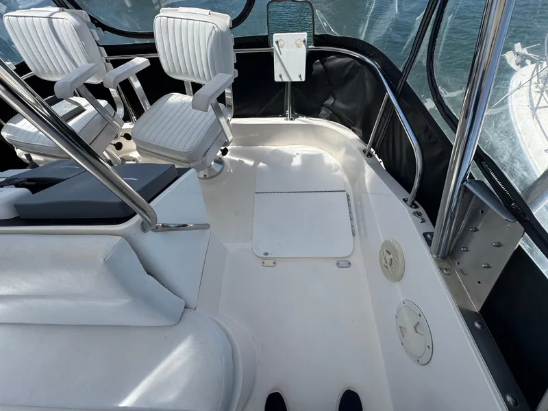 Slide: The Image of 2003 Mediterranean 38 Convertible boat interior with white seating and sleek design. - 46