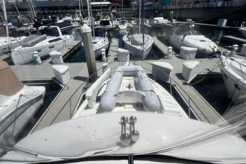 Slide: The Image of 2003 Mediterranean 38 Convertible yacht docked at a marina with other boats. - 50